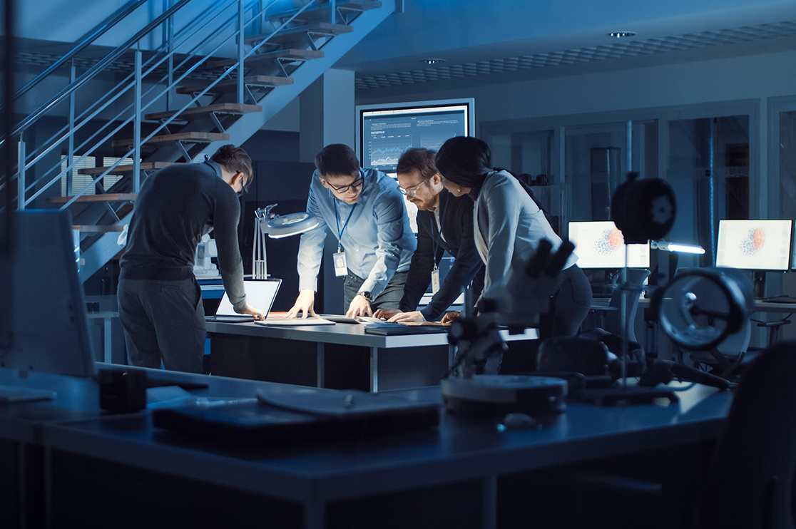 3D rendering team collaborating around 3D Rendering images in a technology-enabled studio with computer workstations and digital design displays