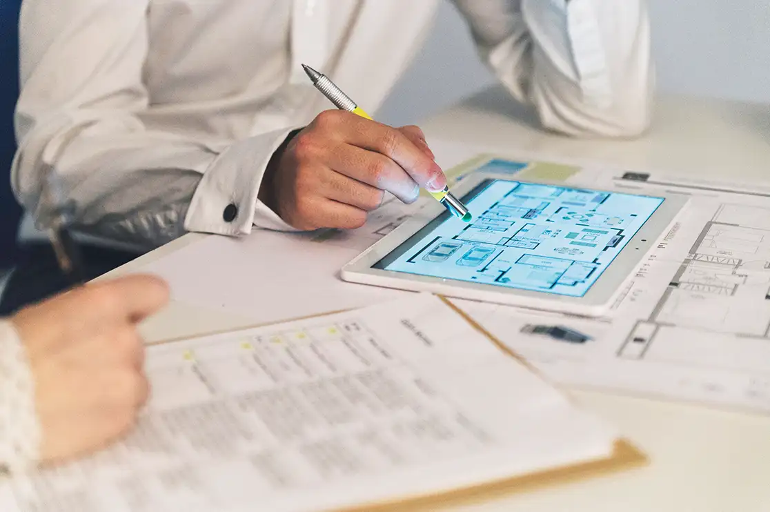 Construction professionals reviewing a BIM Execution Plan with digital building drawings