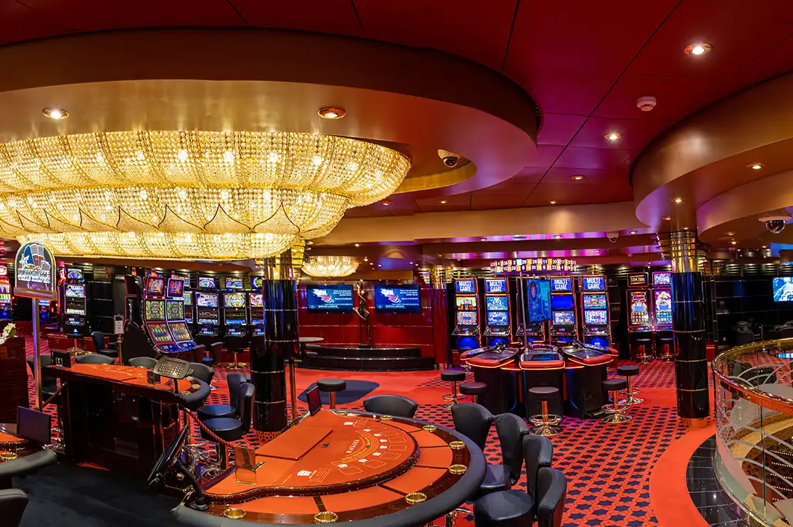 Casino millwork combining multiple materials across gaming tables, cabinetry, and decorative finishes.