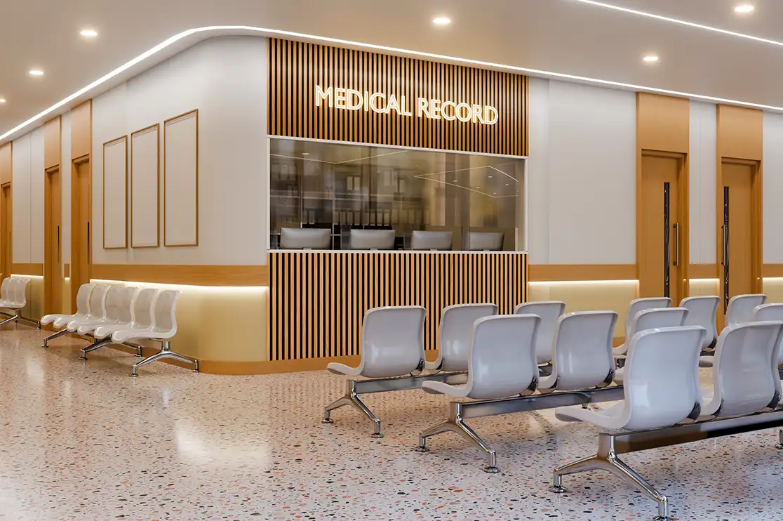 Hospital medical records reception area featuring wood-slat millwork, built-in service counters, and patient waiting chairs.
