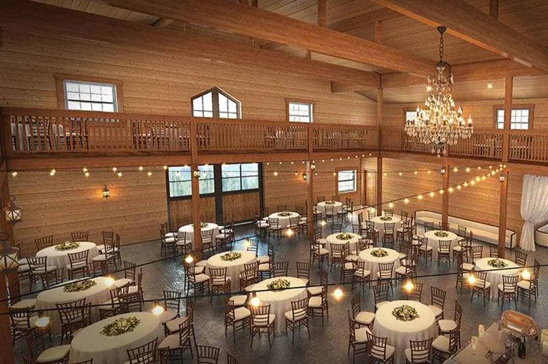 Wooden restaurant or event hall interior with custom wood wall paneling, exposed beams, balcony railing, chandelier, and round dining tables, illustrating millwork drafting services for restaurant chains