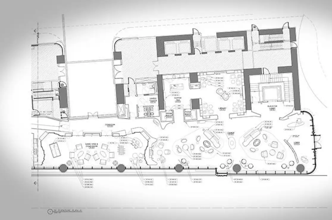 Interior construction floor plan showing shared living areas, seating arrangements, service spaces, and circulation paths for senior living and multifamily housing projects.
